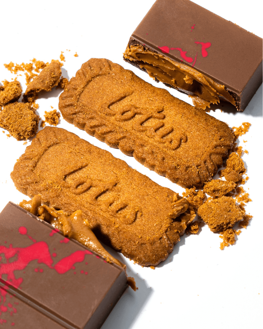 Cracked Speculoos chocolate bar showing creamy filling with Lotus Biscoff biscuit between